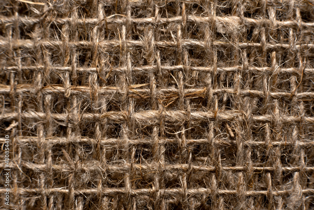 Cloth. The texture of the burlap fabric is close-up. Packaging material. Background Of Burlap Hessian Sacking Cloth. The texture of the burlap fabric is close-up. Packaging material. Background Of Burlap Hessian Sacking