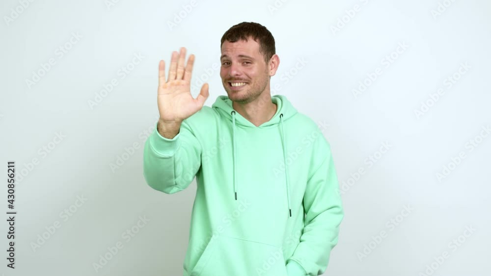 Brazilian handsome man saluting with hand with happy expression over isolated background Brazilian handsome man saluting with hand with happy expression over isolated background