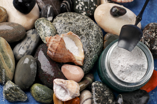 Natural supplement. Marine collagen powder on the background of stones. Healthy lifestyle concept. Hydrolyzed collagen in a glass jar.