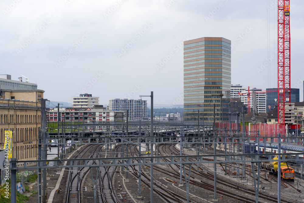 Railway station Zurich Oerlikon with skyscraper Andreasturm (Andreas tower) in the background. Photo taken April 29th, 2021, Zurich, Switzerland. Railway station Zurich Oerlikon with skyscraper Andreasturm (Andreas tower) in the background. Photo taken April 29th, 2021, Zurich, Switzerland.