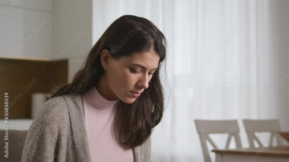 Portrait of a young attractive caucasian woman looking for a solution while working on her laptop Portrait of a young attractive caucasian woman looking for a solution while working on her laptop