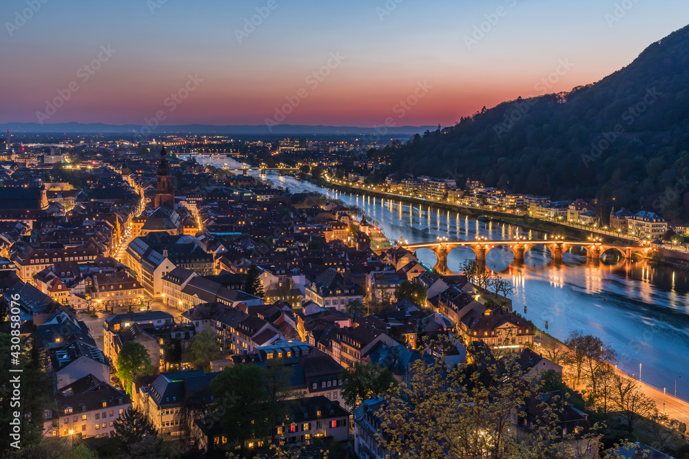 Heidelberg panorama with old city, old bridge and Neckar river after sunset. Beautiful illuminated.
