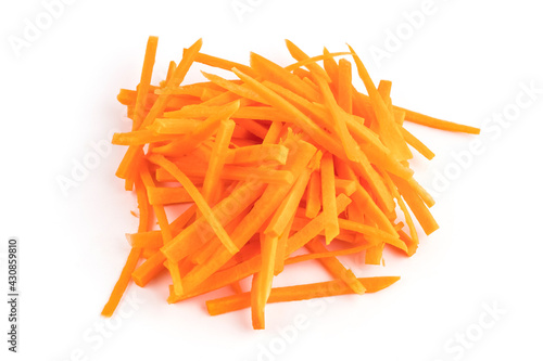 bunch of carrots cut into strips on a white kitchen board. Cut the carrots into long strips. Close-up