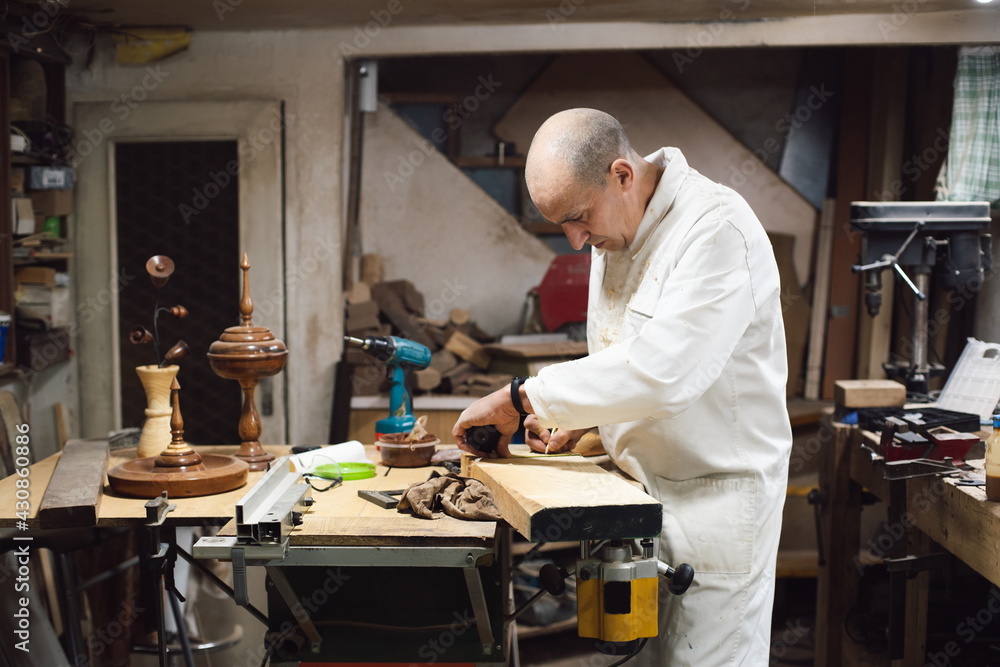 Cabinetmaker working with a wooden board Cabinetmaker working with a wooden board