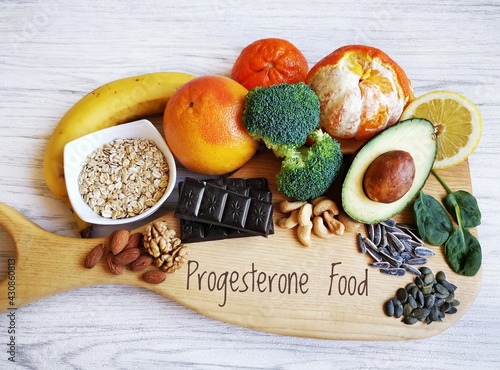 Progesterone boosting foods rich in vitamin and mineral. Nutrients to increase progesterone naturally. Best food sources for low progesterone, and hormone balance. Banana, avocado, citrus, seeds, nuts photo