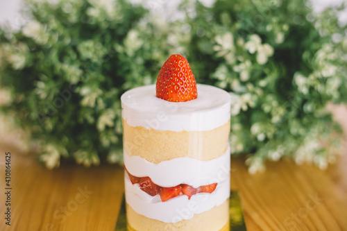 Strawberry shortcakes with whipped cream and fresh berries on wooden table