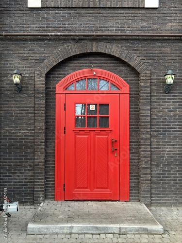 Beautiful red door in a brick wall