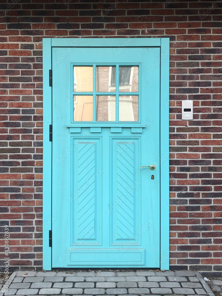 Beautiful blue door in a brick wall Beautiful blue door in a brick wall