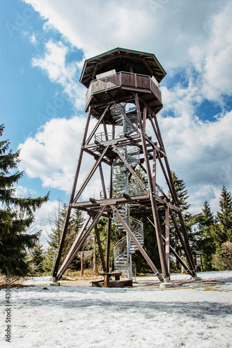 Wooden observation tower called Anna on Anensky Peak in Orlicke Mountains,Czech Republic.Spiral staircase of lookout tower, construction with metal steps and oak platform.Czech tourist place. photo