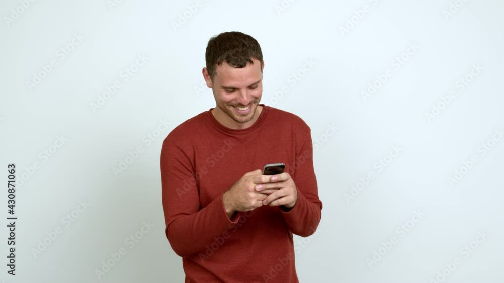 Brazilian handsome man using mobile phone over isolated background Brazilian handsome man using mobile phone over isolated background