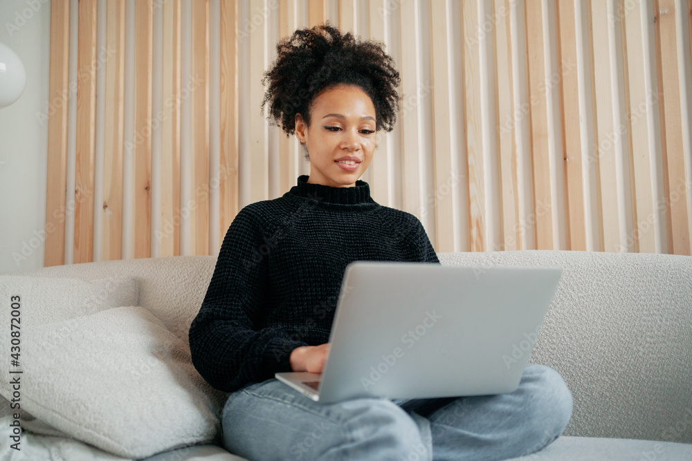Holds a laptop computer in his hands. Online distance learning. A woman of African-American appearance is a smart student getting an education via video link. Holds a laptop computer in his hands. Online distance learning. A woman of African-American appearance is a smart student getting an education via video link.