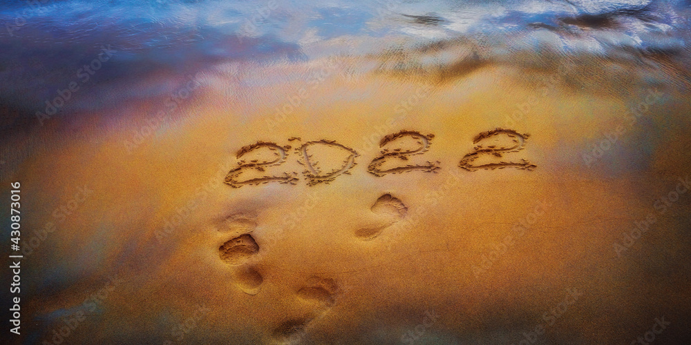 Obraz na plátně 2022 is drawing on yellow sand on a beach with a wave by the sea