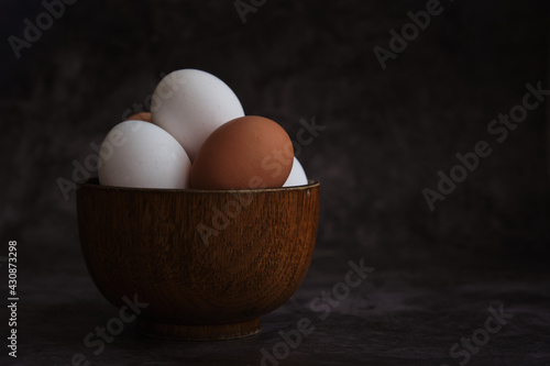 white and brown chicken eggs in the bowl