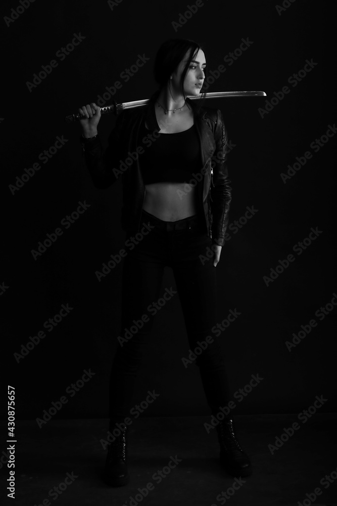 Woman with katana sword in black and white Woman with katana sword in black and white