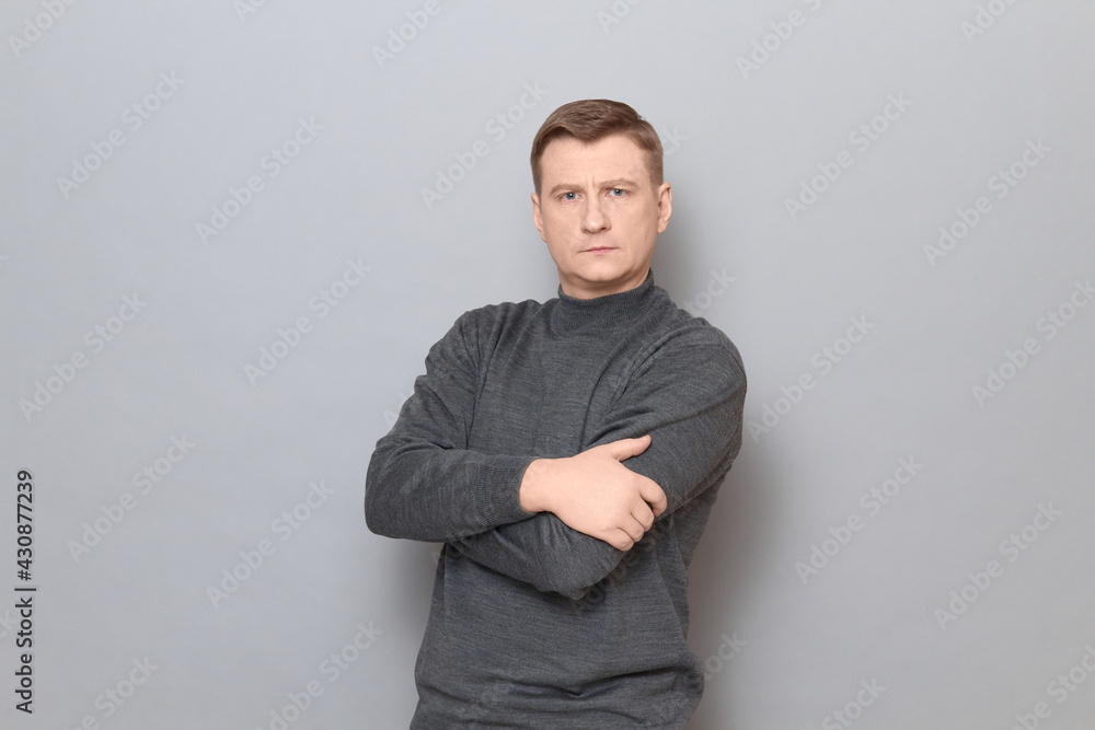 Portrait of blond mature man holding arms crossed on chest Portrait of blond mature man holding arms crossed on chest