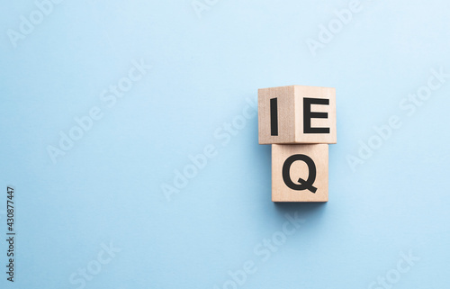 wood cube the expression IQ Intelligence Quotient to EQ Emotional Intelligence Quotient