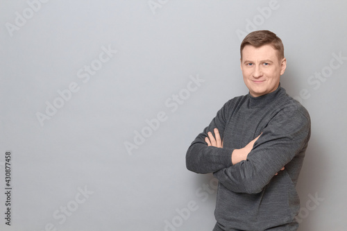 Фотография Portrait of happy mature man holding arms crossed on chest and smiling
