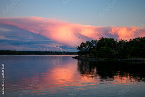 Sun illuminating clouds over a lake in beautiful colors