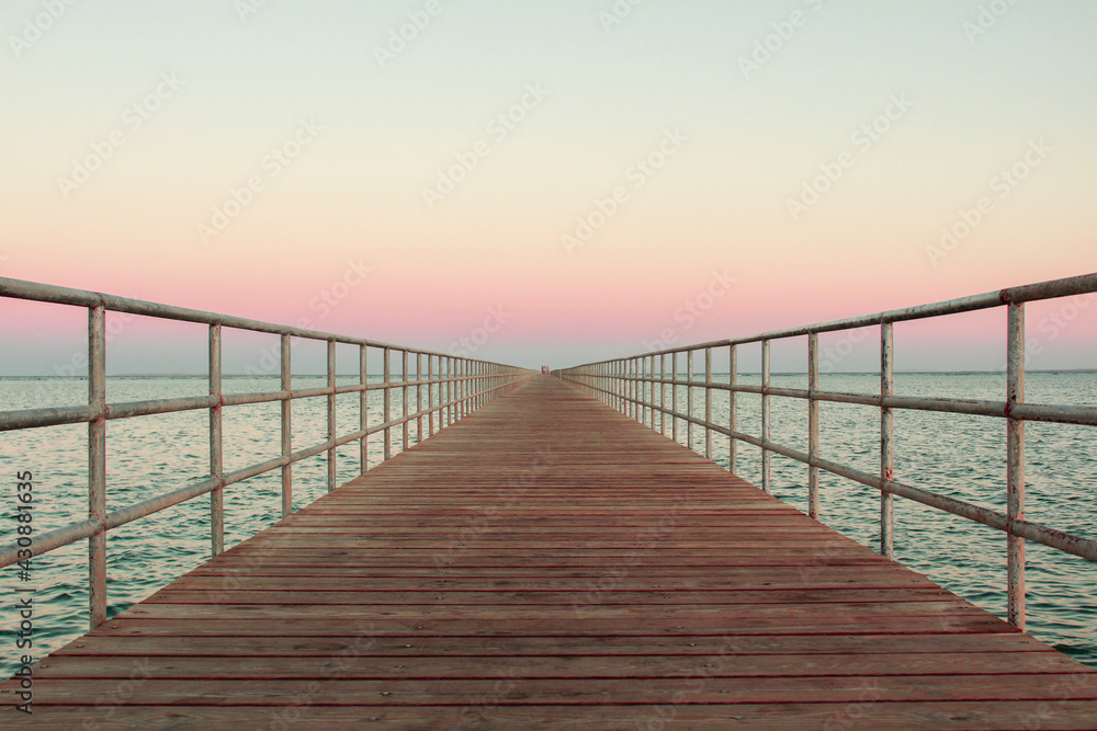wooden bridge over the sea, summer sunset 