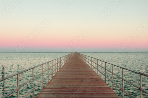 wooden bridge over the sea, summer sunset 