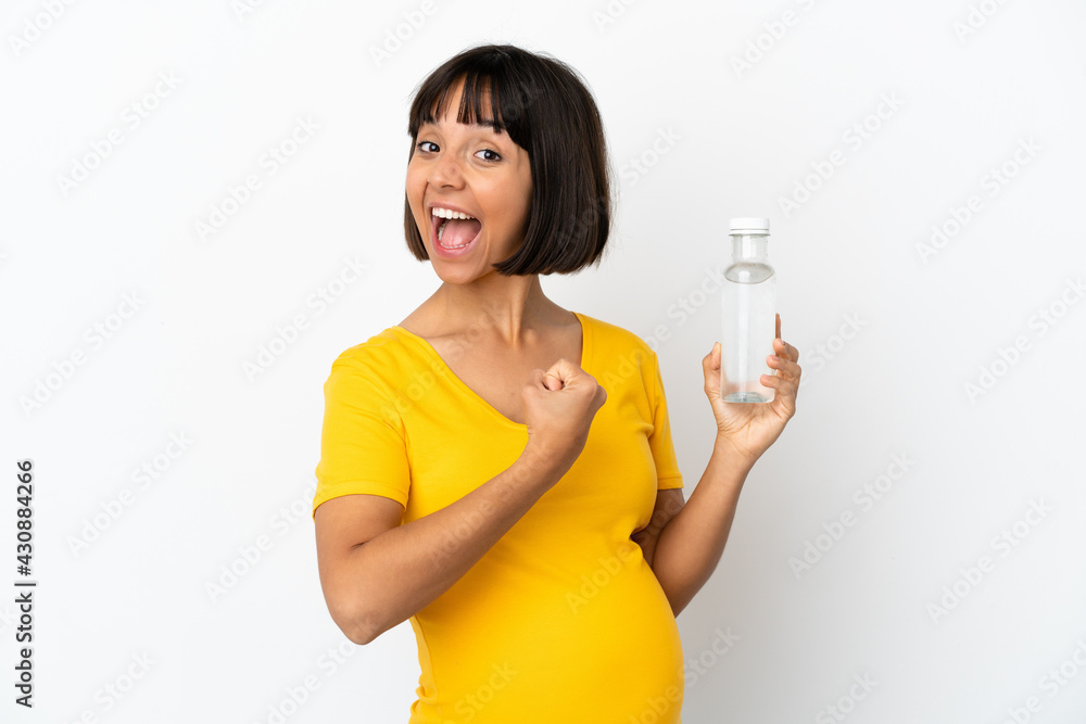 Young pregnant woman holding a bottle of water isolated on white background celebrating a victory Young pregnant woman holding a bottle of water isolated on white background celebrating a victory