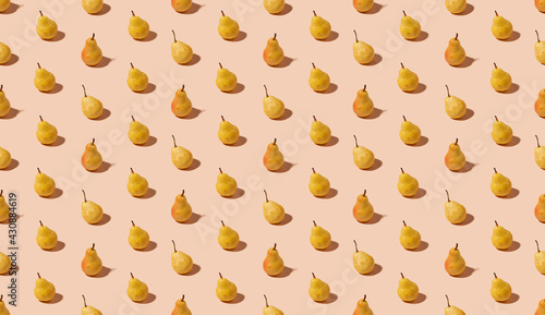 Seamless isometric pattern with summer fruits - fresh yellow and orange pears on pastel orange background