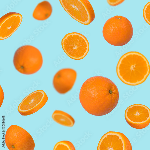 Creative idea with fresh orange sliced on pastel blue background.