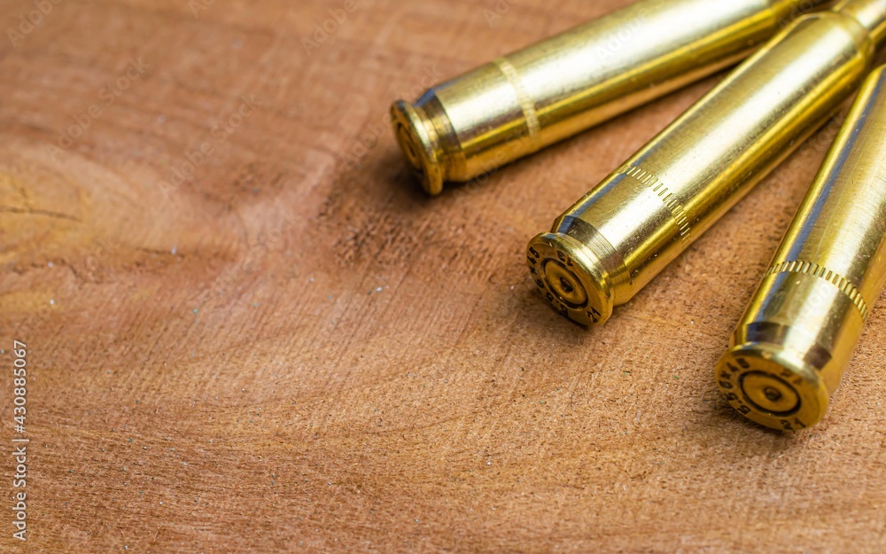 brass rifle shells.5.56 x 45 cartridges on a wooden board brass rifle shells.5.56 x 45 cartridges on a wooden board