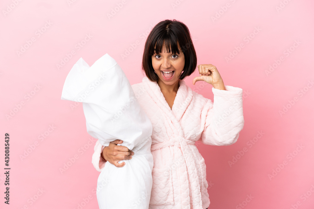 Young mixed race pregnant woman isolated on pink background in pajamas and proud of self-satisfied Young mixed race pregnant woman isolated on pink background in pajamas and proud of self-satisfied