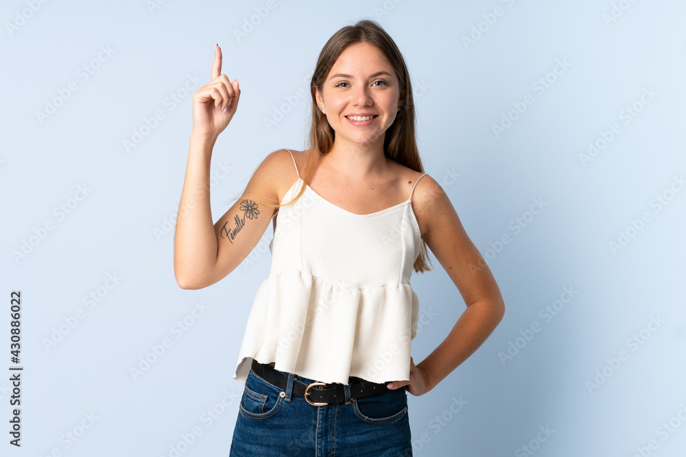Young Lithuanian woman isolated on blue background pointing up a great idea Young Lithuanian woman isolated on blue background pointing up a great idea