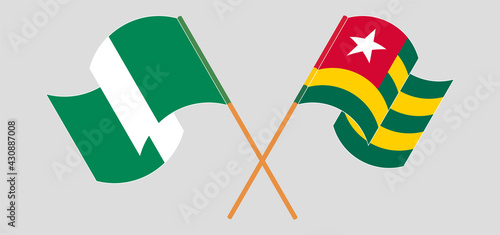 Crossed and waving flags of Nigeria and Togo