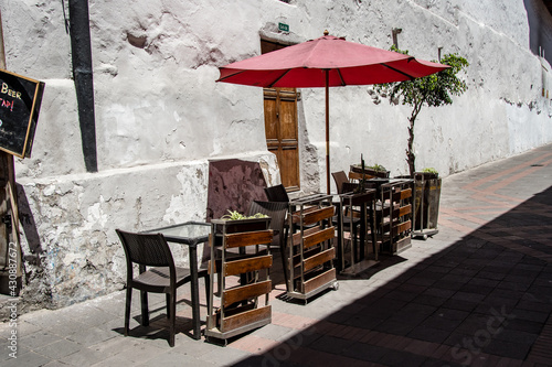 Tables and chairs are ready to welcome thirsty customers outside a small bar in the streets of Quito