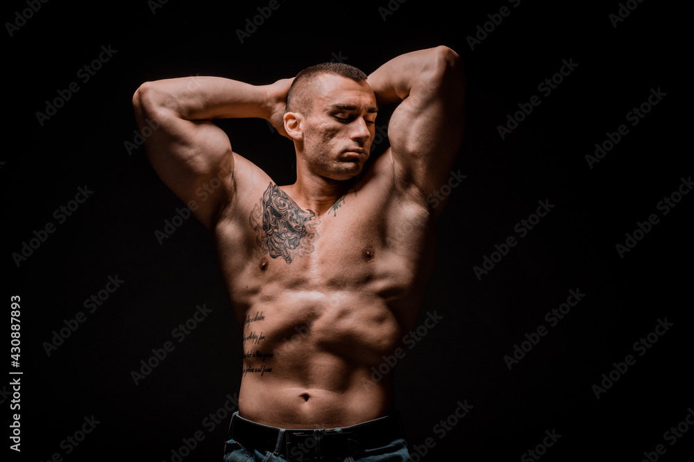 Fototapeta premium Young bodybuider posing in studio