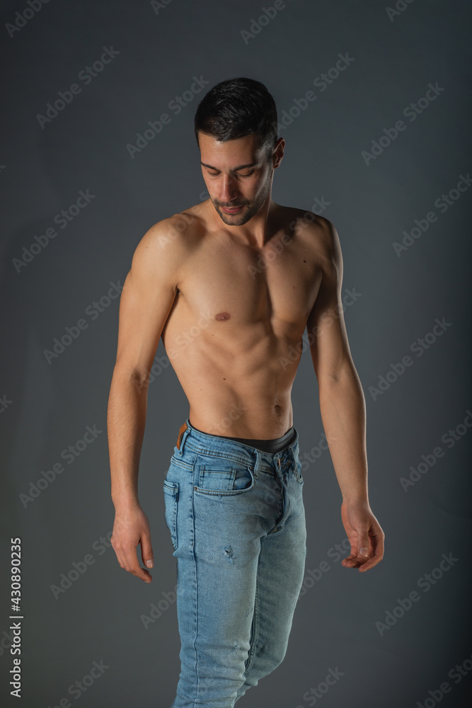 Studio portrait of a shirtless sexy man with abs in denim blue jeans Studio portrait of a shirtless sexy man with abs in denim blue jeans