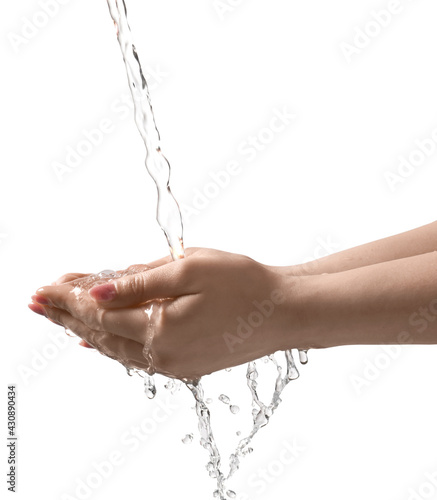 Pouring water into woman's hands on grey background, closeup