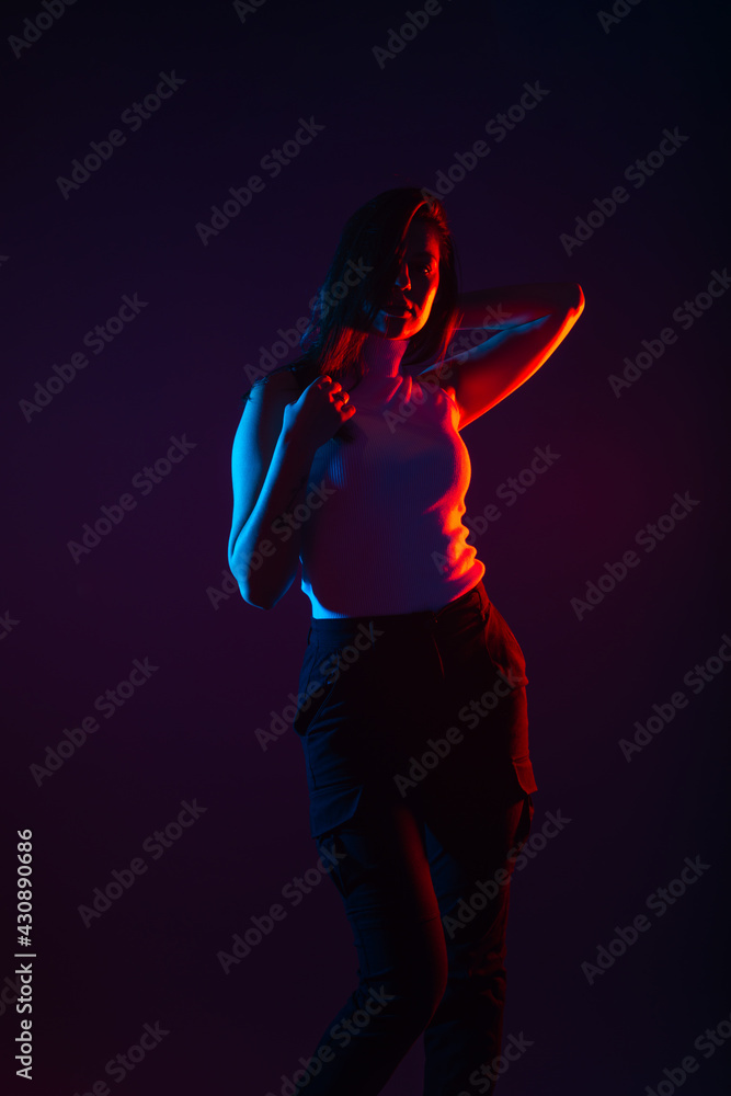 Blue and red light portrait of a female model on a black background with high contrast Blue and red light portrait of a female model on a black background with high contrast