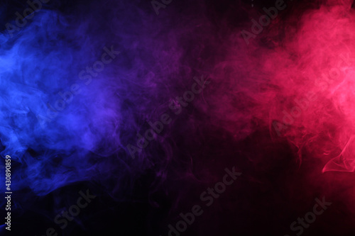 Smoke in red-blue light on black background