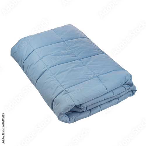The blue cotton blanket is folded several times. White isolated background. Side view