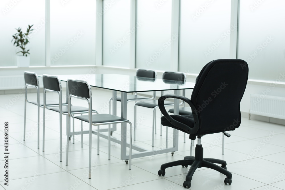 Black chairs glass table in office space Black chairs glass table in office space