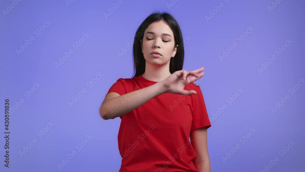 Woman using invisible touchscreen on violet studio background. She swiping, clicking, tapping on air screen. Technology, interface concept. Woman using invisible touchscreen on violet studio background. She swiping, clicking, tapping on air screen. Technology, interface concept.