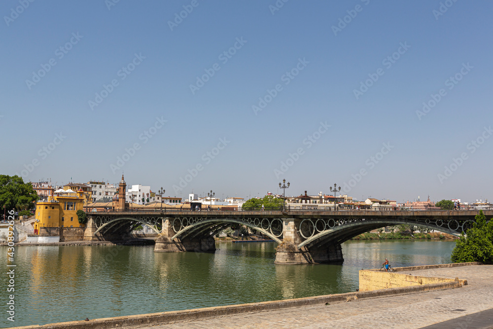 Views of the Triana bridge over the Guadalquivir river in Seville, Spain