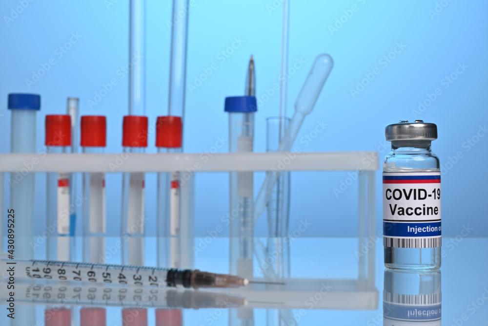 Russian Covid-19 vaccine vial on a lab desk. Chemical glassware and test tubes for pharmacy development. Medical test of coronavirus inoculation fluid. Chemical research laboratory with flasks. Russian Covid-19 vaccine vial on a lab desk. Chemical glassware and test tubes for pharmacy development. Medical test of coronavirus inoculation fluid. Chemical research laboratory with flasks.