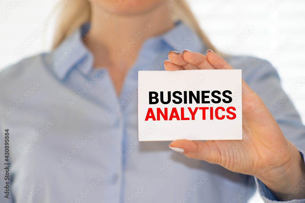 Business Analytics. Man holding a card with a message text written on it Business Analytics. Man holding a card with a message text written on it