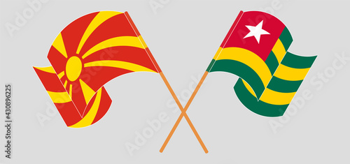Crossed and waving flags of North Macedonia and Togo