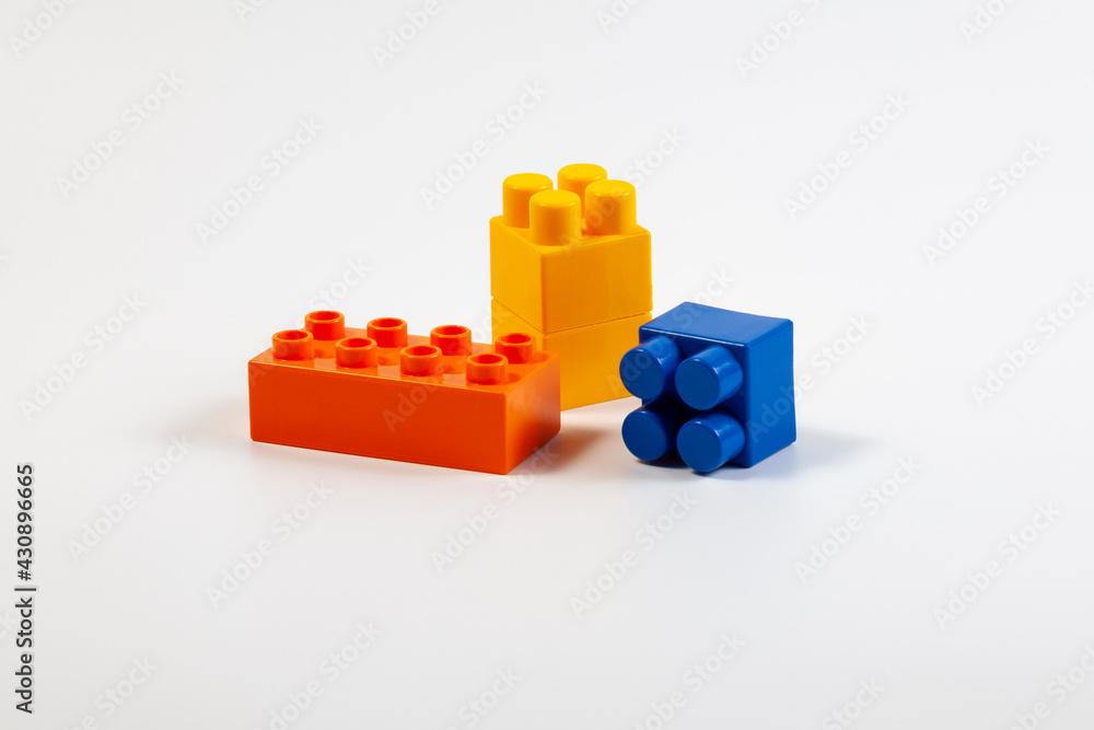 Fototapeta premium Multicolored blocks of children's constructor on a white background
