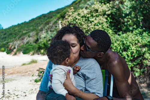 Family kiss at beach