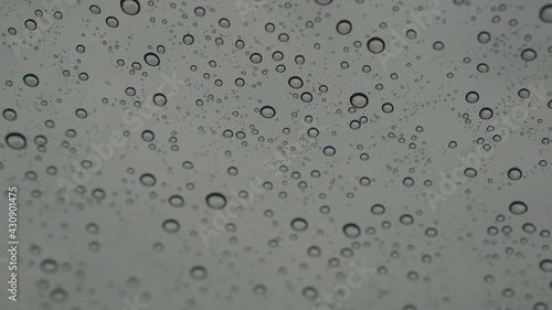 Rain drops are sticking with the glass.