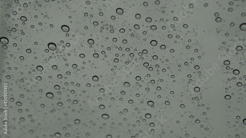 Rain drops are sticking with the glass.