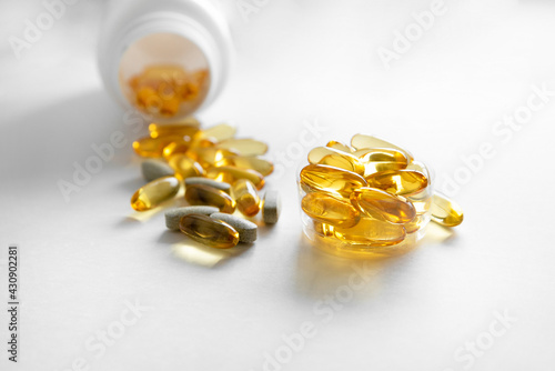 Close up of food supplement oil filled capsules suitable for: fish oil, omega 3, omega 6, omega 9, evening primrose, borage oil, flax seeds oil, vitamin A, vitamin D, vitamin D3, vitamin E.