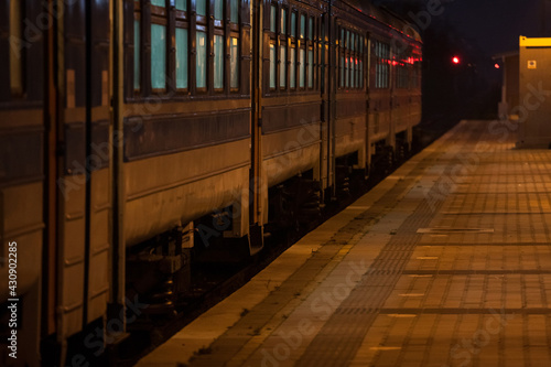 Selective blur on the doors of a suburban train of a commuter train station of Belgrade, Serbia, on an empty platform, at night.